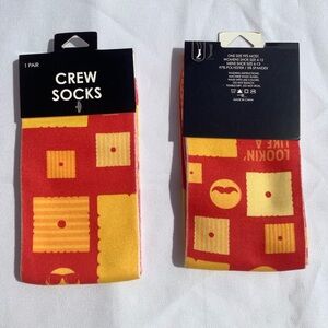 A Pair of Kelloggs Themed Snack Piece Face Crew Socks Red Orange and Yellow